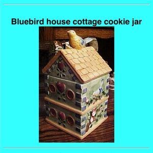 Birdhouse cottage cookie jar with a blue bird on top.